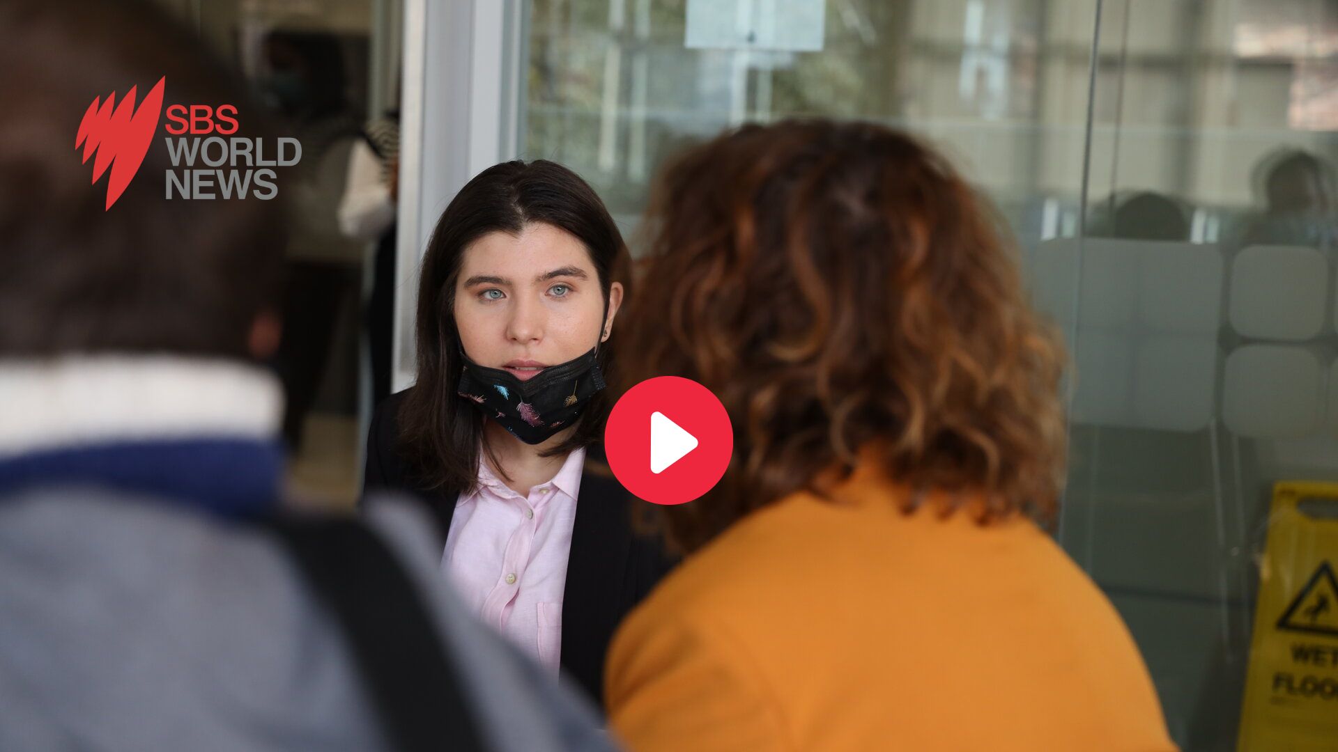 Jigsaw trainee, Laura is looking at Amanda Rishworth. SBS World News logo is top left